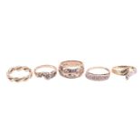 A collection of five 9ct yellow gold rings comprising a woven-style band, size M1/2, a gypsy-set rin