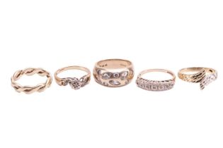 A collection of five 9ct yellow gold rings comprising a woven-style band, size M1/2, a gypsy-set