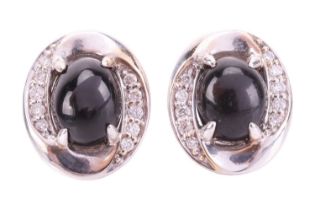 A pair of Whitby jet and diamond stud earrings in 18ct white gold, each containing an oval jet