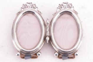 An Edwardian silver duet photo frame, the hinged frames with bow decoration, each measuring 9 x 5.