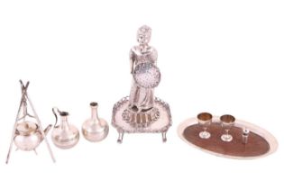 A collection of silver miniatures including a tea kettle suspended on a tripod, a flagon, two dining