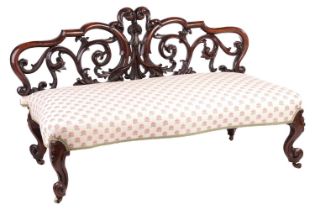 An unusual Victorian rosewood window seat/Couch, with an openwork back carved with scrolls over a