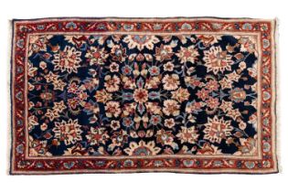 A small dark blue ground Kerman rug, contemporary, with palmette and floral spray design within a