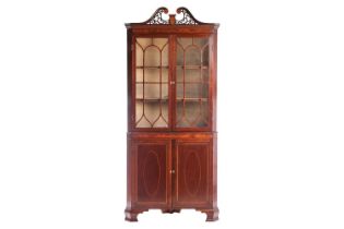 An Edwardian mahogany and marquetry inlaid free-standing double corner display cabinet, by Arthur