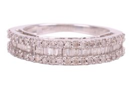 A diamond-set ring, featuring baguette-cut diamonds flanked by two rows of round brilliant diamonds,