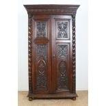 Oak two-door cupboard with 4 carved panels of garlands, putto, shell motifs and crown, flanked by