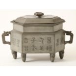 Hexagonal pewter lidded box decorated with Chinese characters and 6-sided red stone knob and