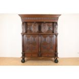 Oak Renaissance cabinet with richly carved crest, recessed elevation with 3 panel doors resting on 4