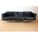 Three-person sofa with black leather cushions on chrome base, modeled after Le Corbusier design,