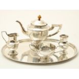 Octagonal silver tableware on oval tray, consisting of teapot, sugar bowl, milk jug and spoon