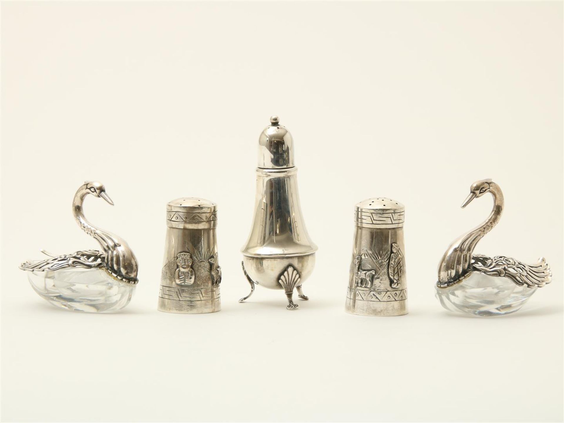 Lot of 5 silver salt cellars and pepper shakers, consisting of: two crystal salt cellars in the