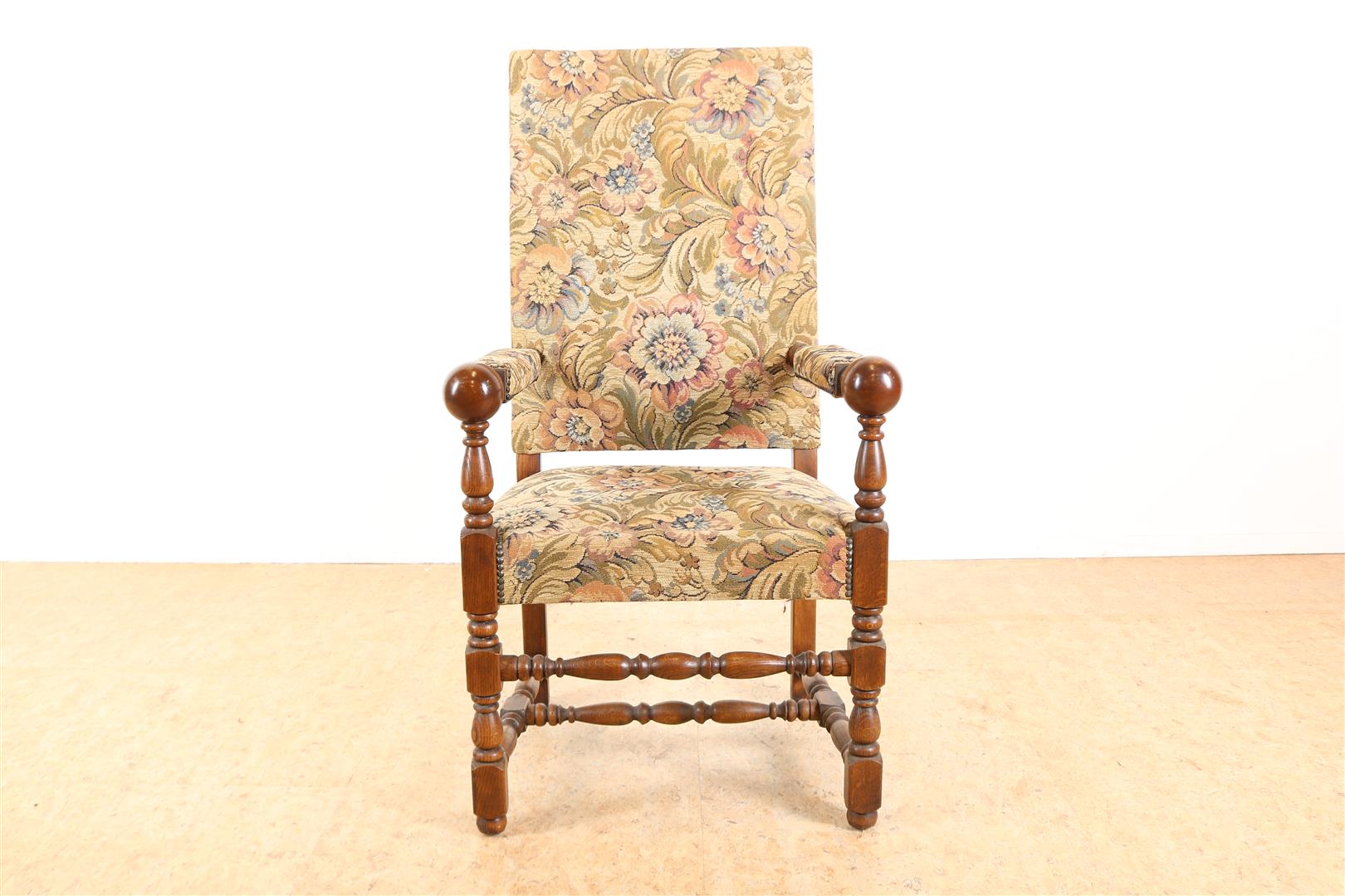 Oak Renaissance style armchair with embroidered upholstery.