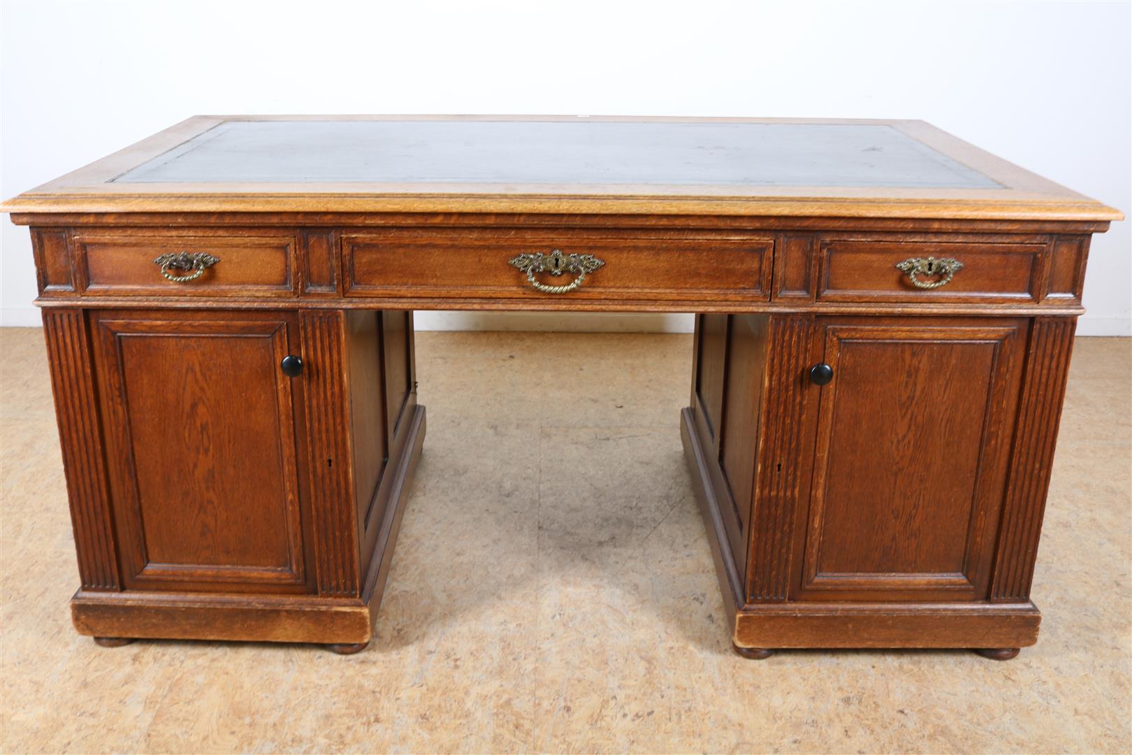 Oak partner desk with black leather inlaid top, 3 sliding drawers and 4 panel doors, late 19th