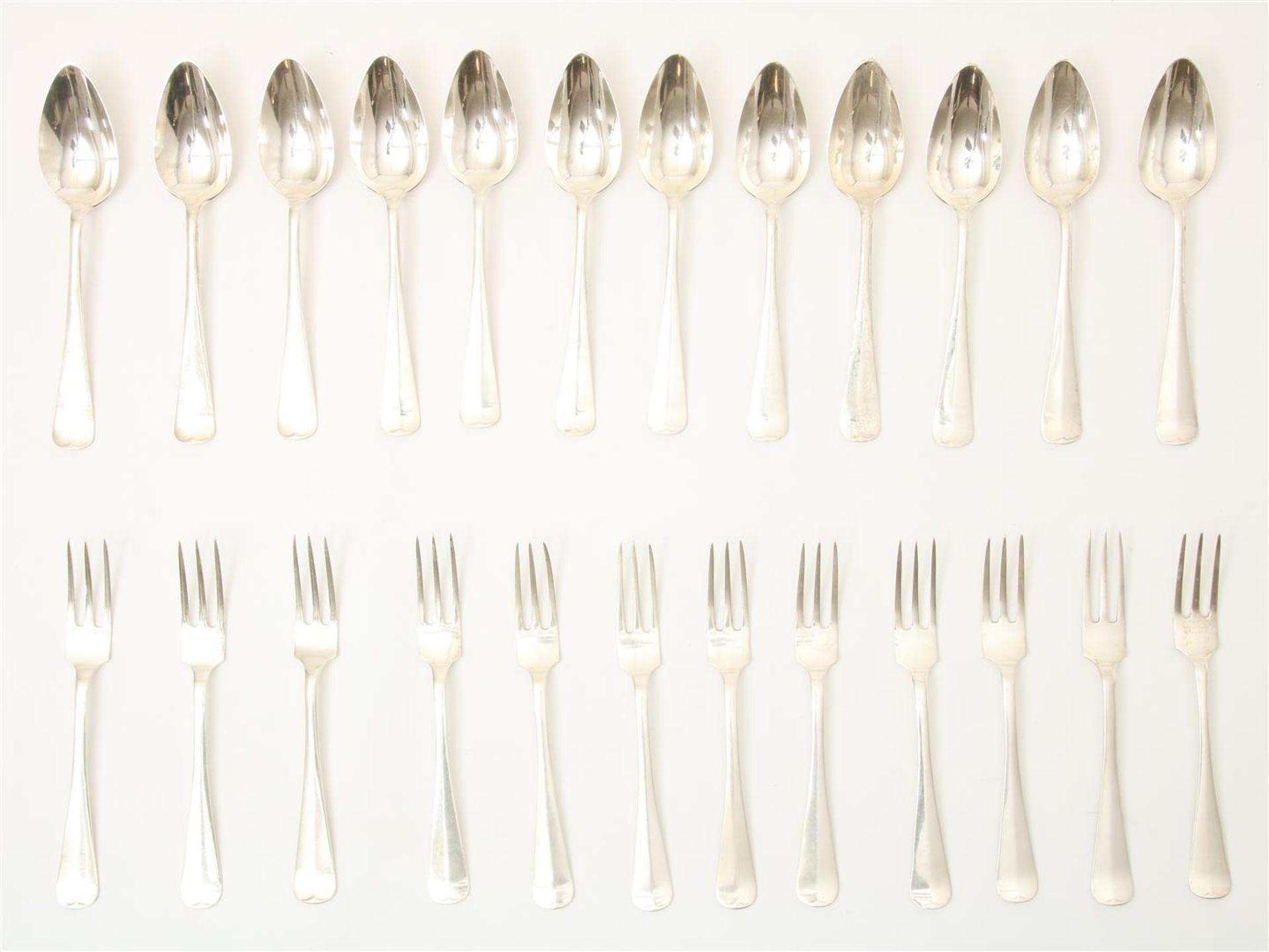 Series of 12 silver small place settings, model Haags lof, grade 835/000, gross weight 882 grams.
