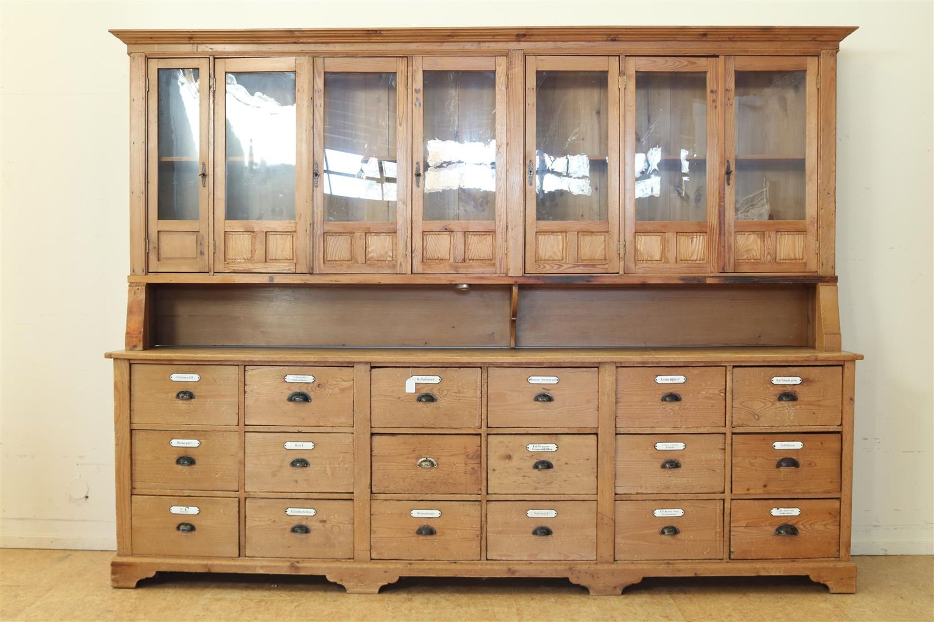 Pine pharmacist's cabinet, upstand with 7 partly glass doors, base cabinet with 18 spice drawers