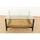 Coffee table with glass top on black metal base and wicker shelf, 38 x 77 x 77 cm.