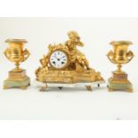 Gilt mantel clock with enamel dial and crowned with a boy listening to a shell on a marble base (