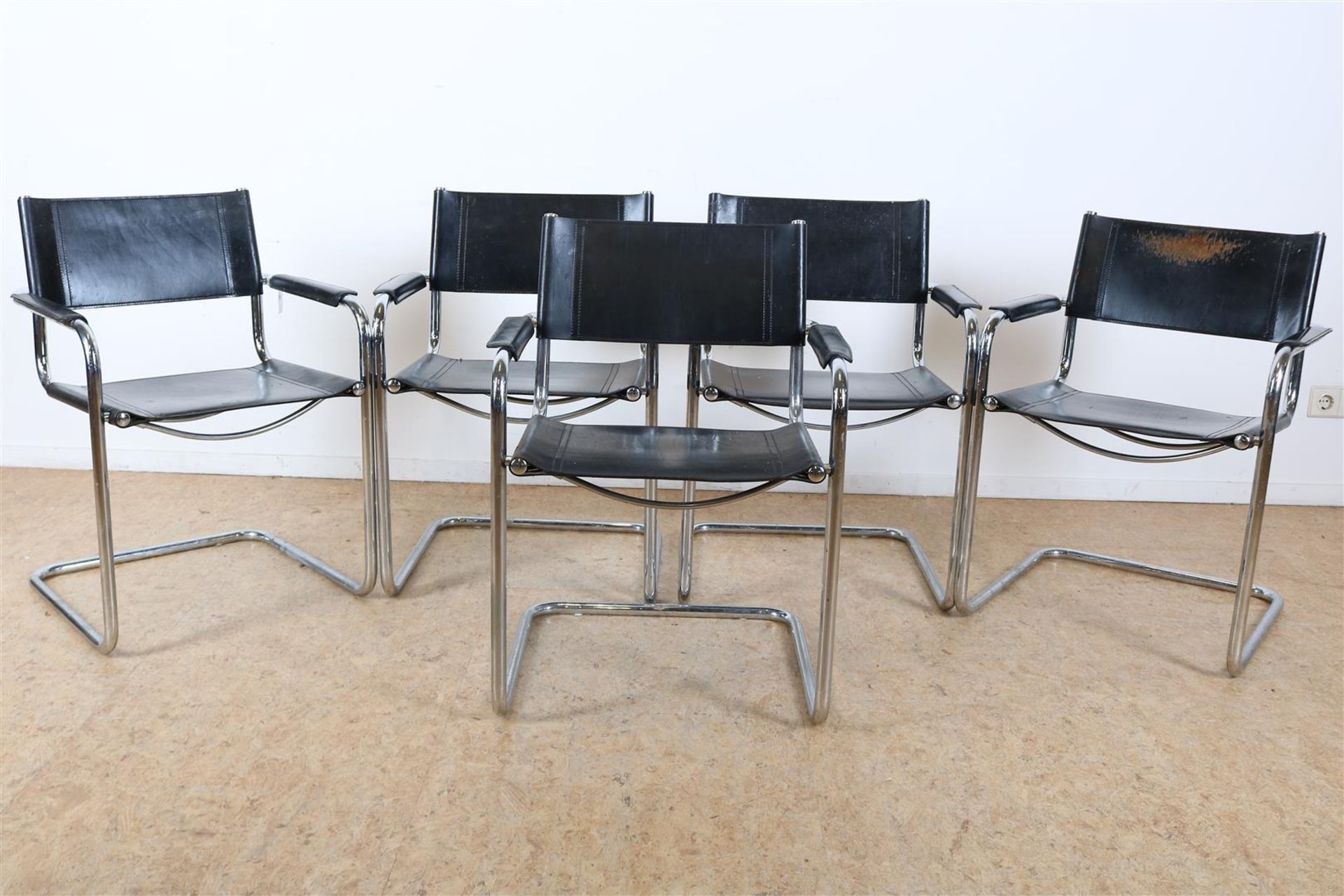 Series of 5 armchairs upholstered in black leather on a chrome tube base, after designer Marcel