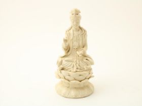 Blanc de chine porcelain sculpture of Guanyin on lotus flower