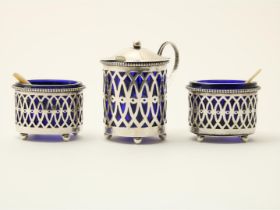 Openwork silver mustardpot and two salt cellars