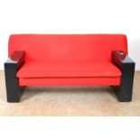 Two-seater sofa with red fabric upholstery and black wooden base, model “Sandwich” (model 750),