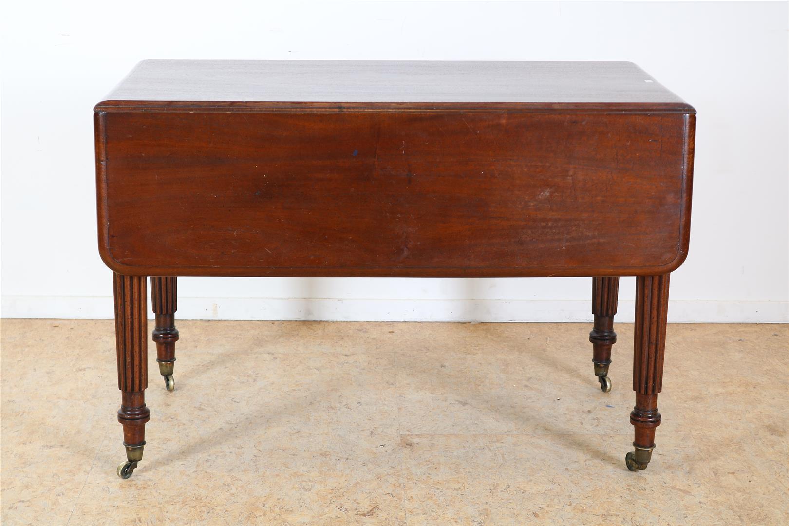 Mahogany George III drop-ear table with cutlery drawer on turned legs and brass wheels, England 19th