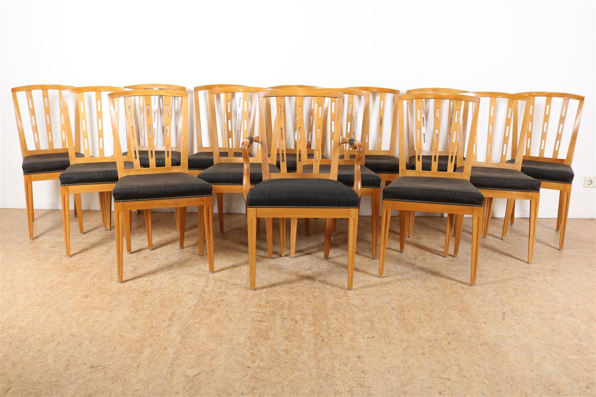 Series of 14 oak chairs with elaborate backrest and green fabric seat, including 1 arm chair.