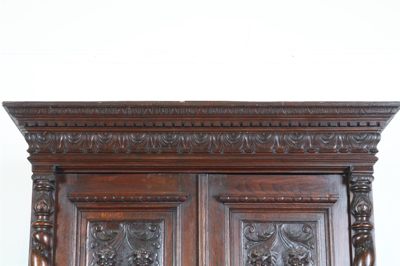 Oak two-door cupboard with 4 carved panels of garlands, putto, shell motifs and crown, flanked by - Image 3 of 9