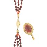 Garnet necklace with 14 carat gold clasp and a 14 carat gold pendant with oval cut garnet.