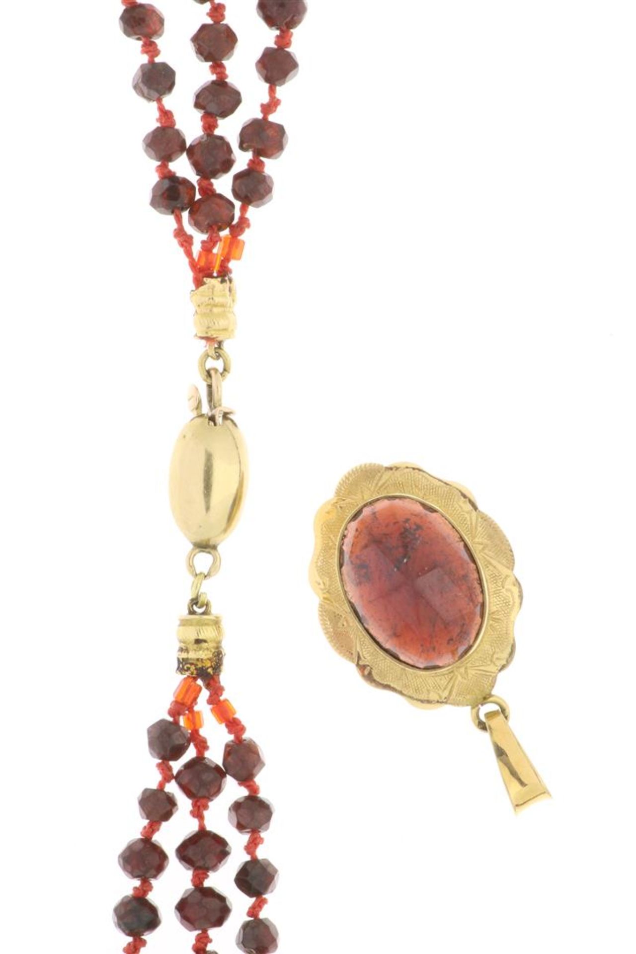 Garnet necklace with 14 carat gold clasp and a 14 carat gold pendant with oval cut garnet.