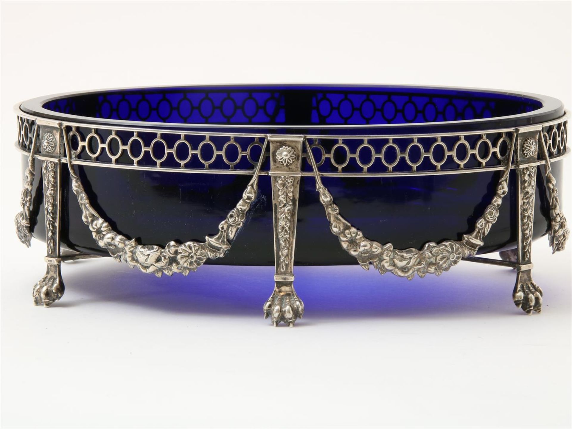 Oval blue glass jardiniere in richly decorated silver frame, resting on claw feet, grade 835/000,