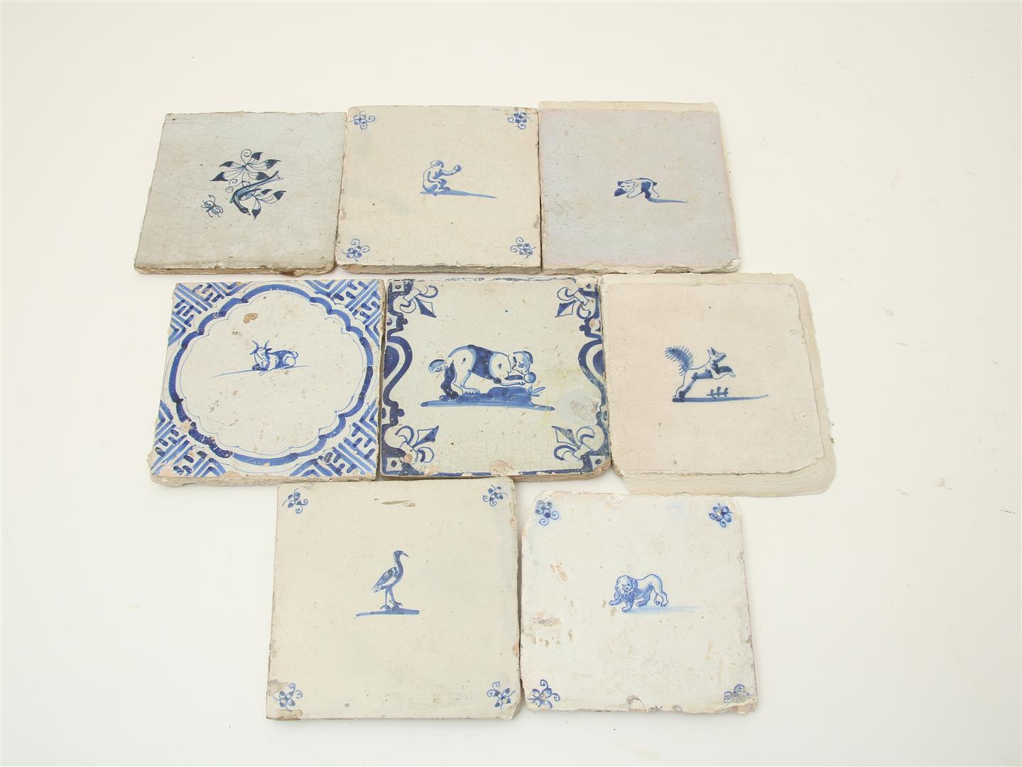 A lot of 8 various earthenware tiles decorated with animal figures, 17th century, lion, monkey,