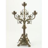 Brass church candlestick for three candles, decorated with leaves and fantasy animals, late 19th