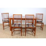 Series of 4 oak Schuitema chairs with openwork backrest and checkered woven seat and an oak table