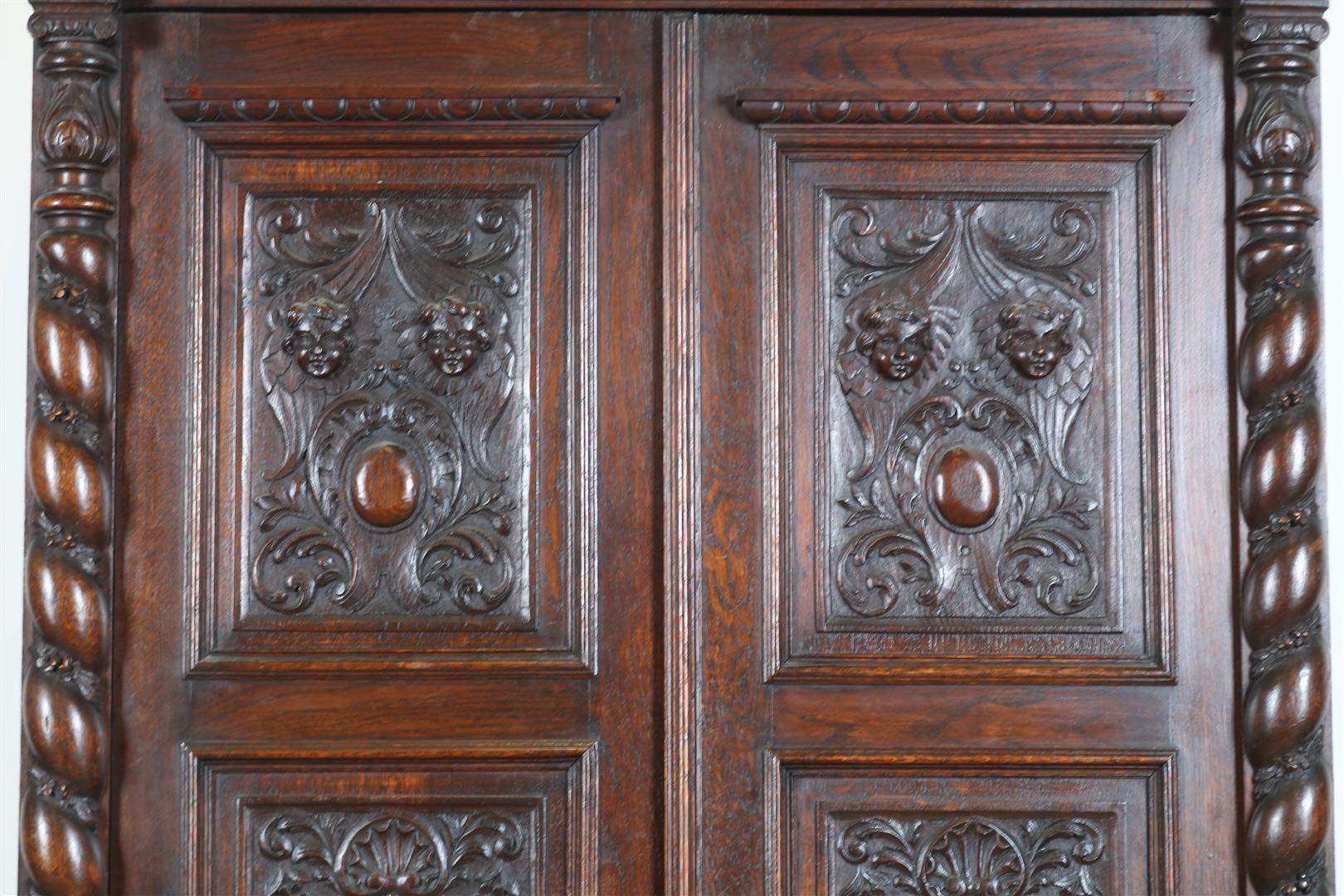 Oak two-door cupboard with 4 carved panels of garlands, putto, shell motifs and crown, flanked by - Image 4 of 9