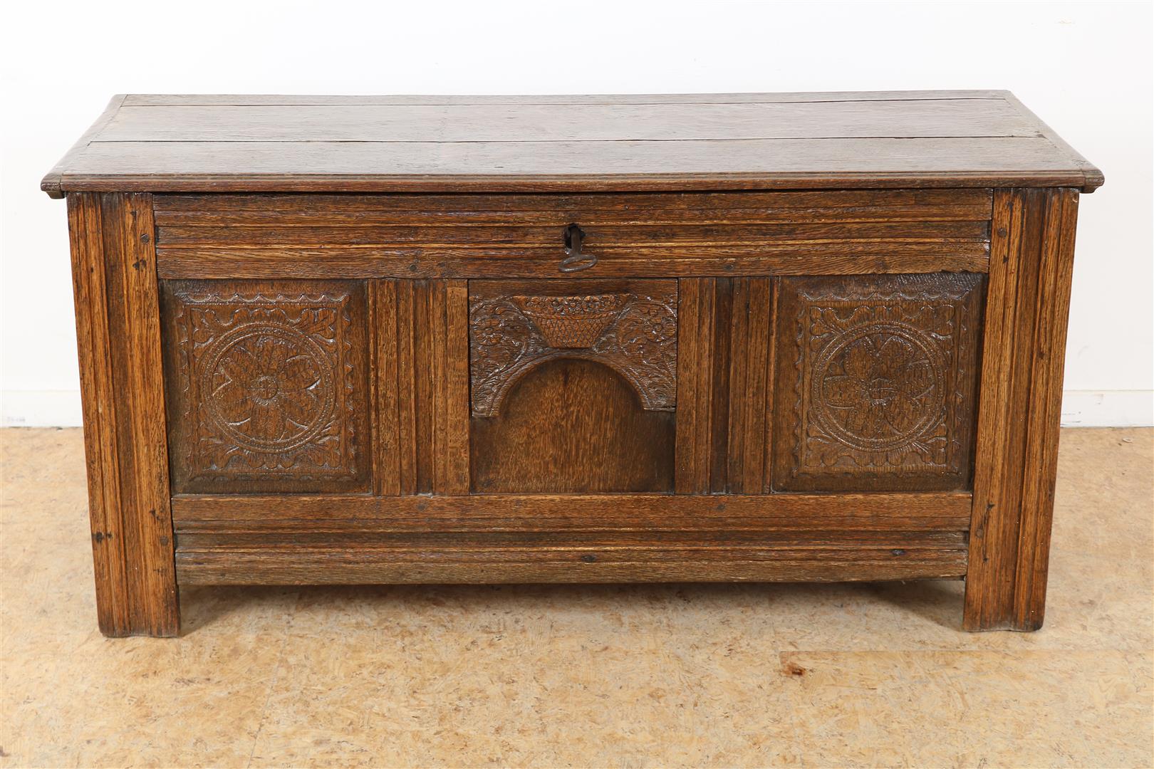 Oak blanket chest with 3 carved front panels with relief decor of a flower basket, iron hinges and