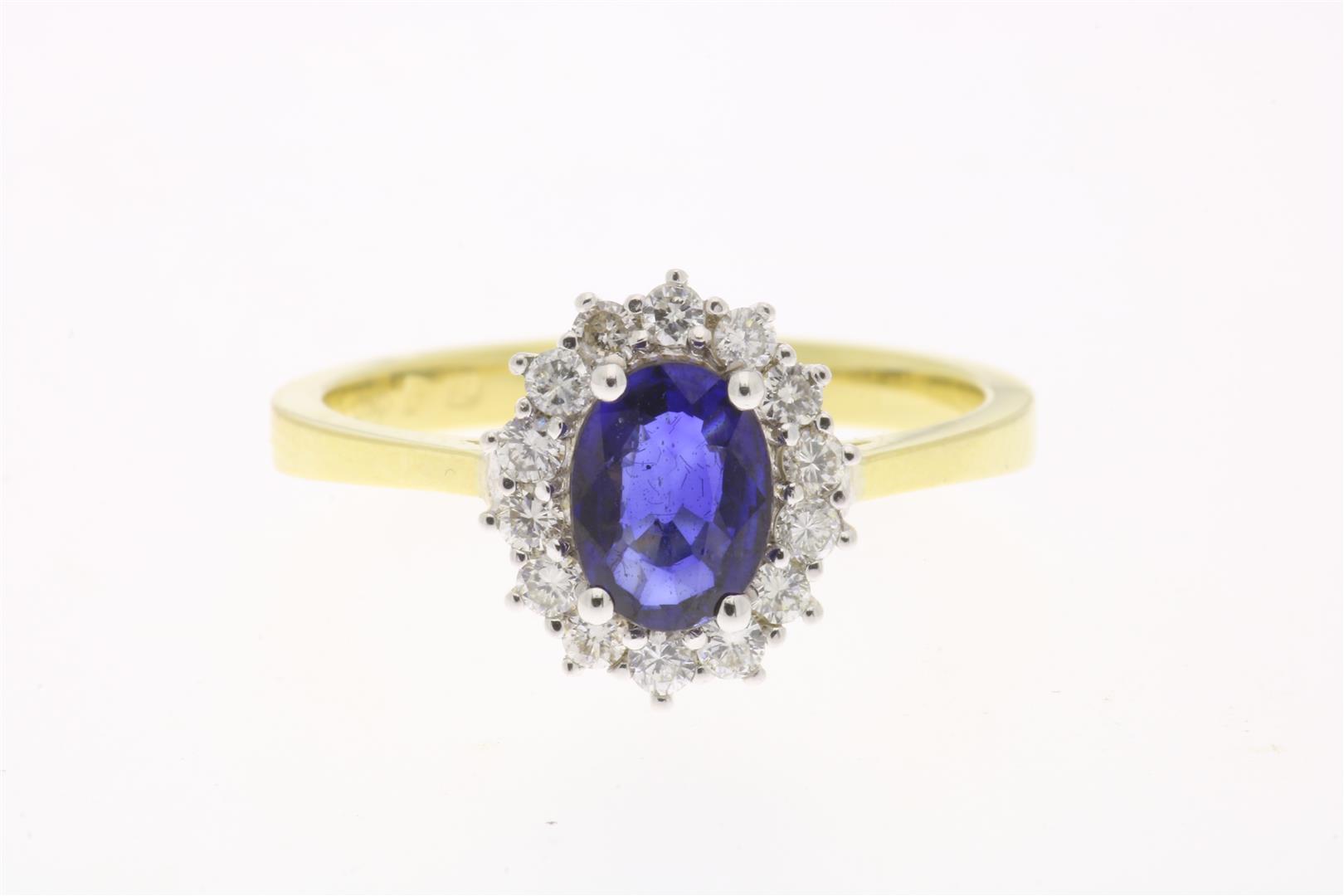 Bicolor gold entourage ring centrally set with a sapphire, approximately 0.70 ct. in an entourage of
