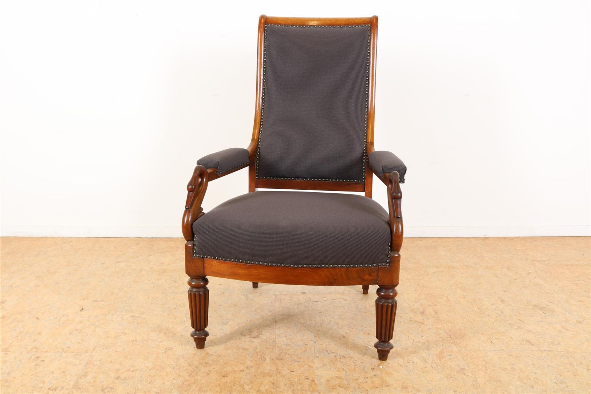 Mahogany armchair with carved swans, covered with ribbed fabric,
