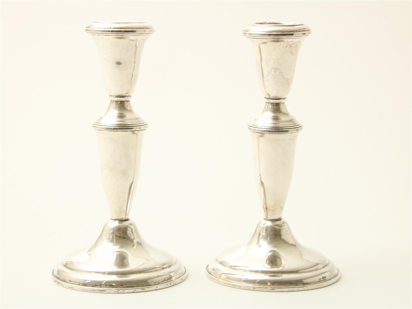 Set of silver one-light candlesticks, height 17 cm, sterling weighted, USA Fith Avenue.