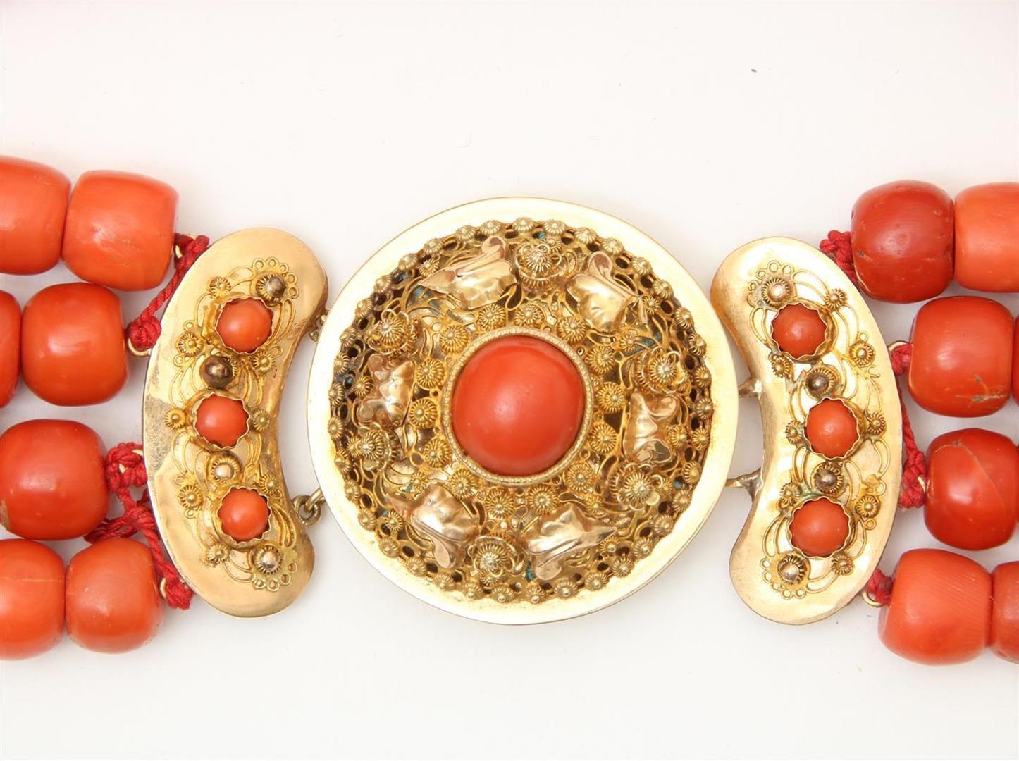 4-row red coral bead necklace with cheese and barrel beads on a gold filigree decorated regional