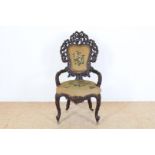 Black Forest chair, with wood carvings of branches and leaves and embroidery, probably Horrix The