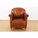 Club armchair upholstered in brown leather.