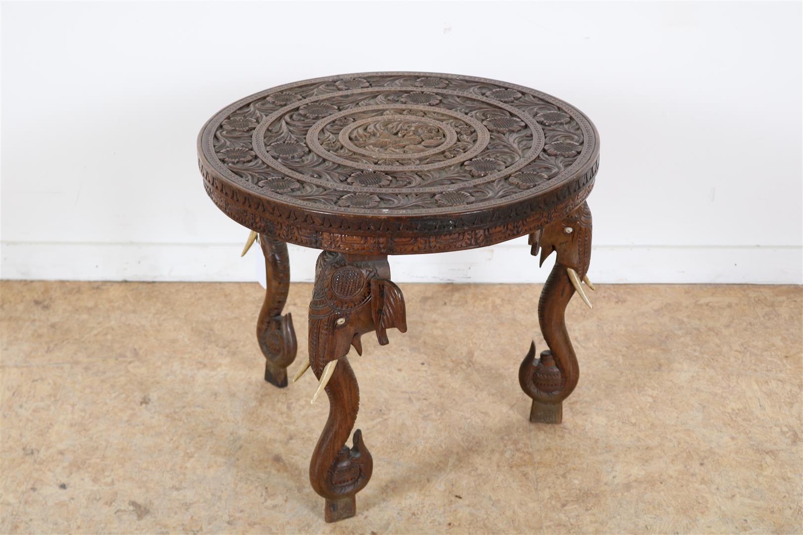Teak elephant table with bone tusks and floral relief top, India, 39 x 46 cm.