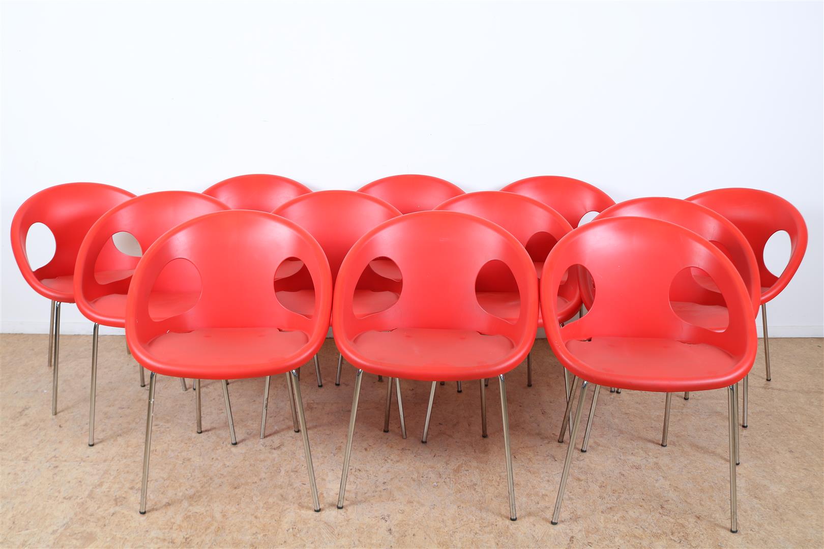 Series of 12 red plastic bucket chairs on chrome legs, marked on the bottom Drop Scab, design