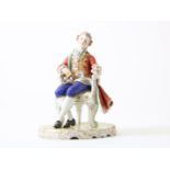 Porcelain sculpture of a seated 18th century gentleman in a chair, marked Sevres S, France 20th