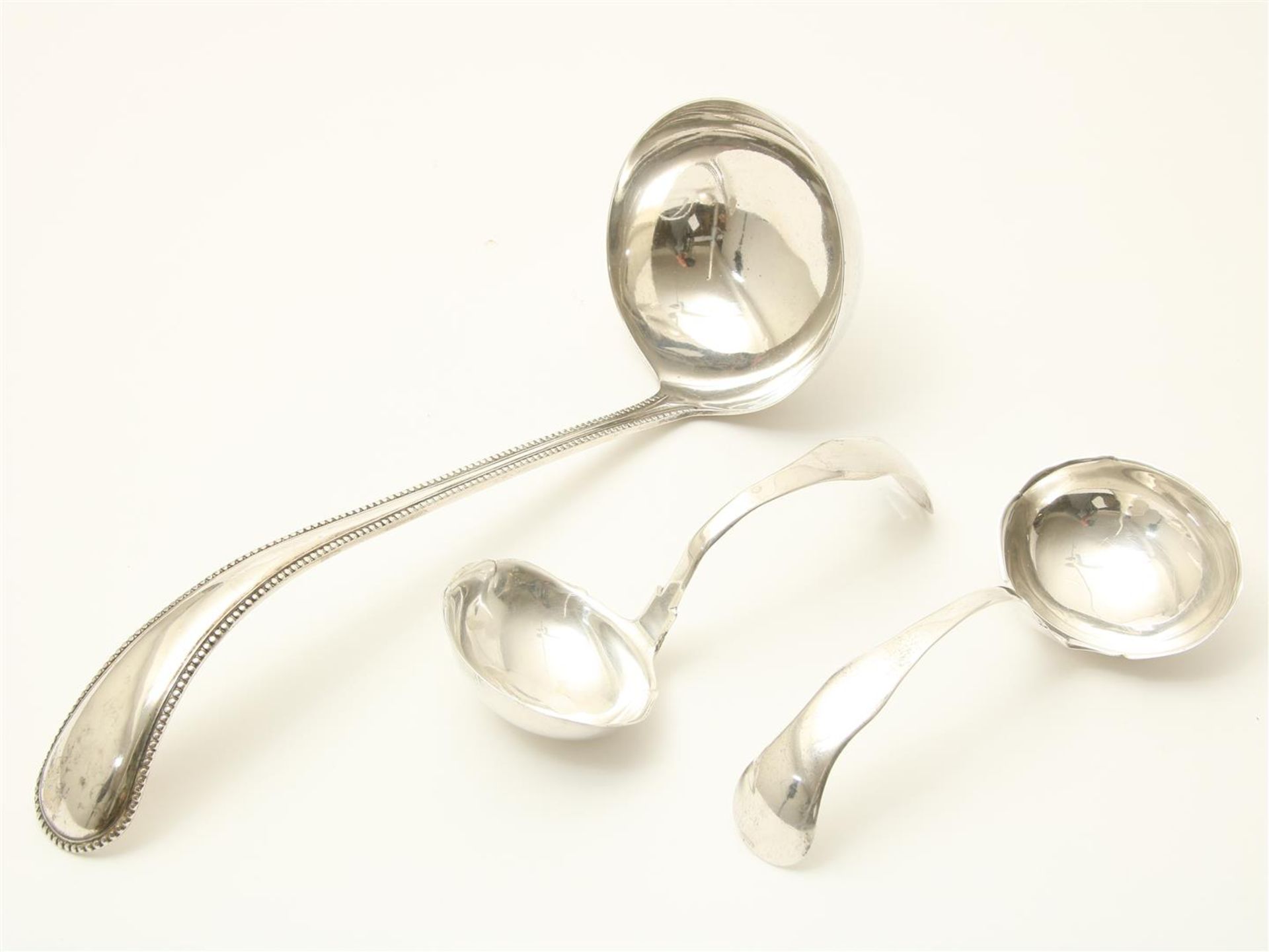 Silver ladle and two gravy spoons