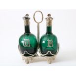 Decanter set, green glass convex belly decanters with plated lid frames in plated mounting. Bristol