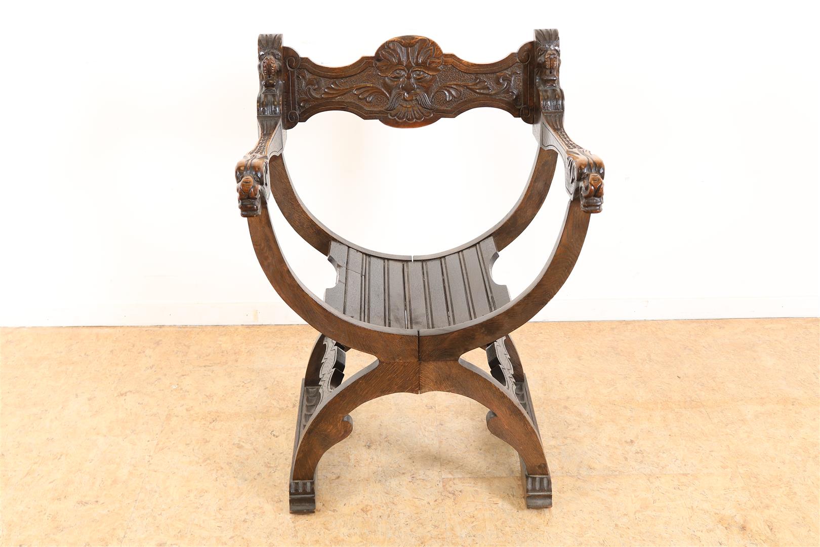 Oak Dagobert armchair with carved maskon in the backrest.