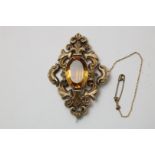 Yellow gold brooch set with citrine, openwork, decorated with C volutes, Biedermeier, 19th
