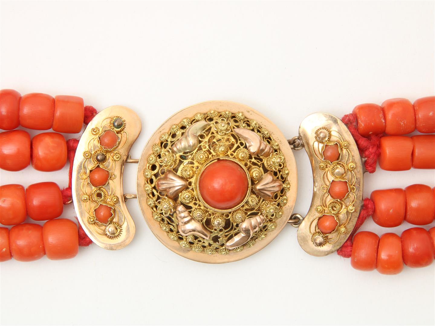 4-row red coral bead necklace with cheese and barrel beads on a gold filigree decorated regional